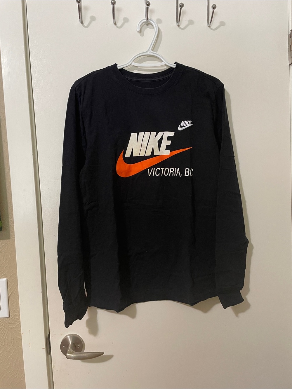 Nike Black Long-Sleeve Tee with Orange Swoosh and White Logo